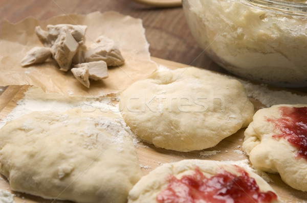 Dough with marmelade on wooden board Stock photo © joannawnuk