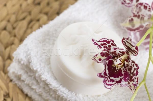 Spa items with white towels, natural soap and orchid Stock photo © joannawnuk