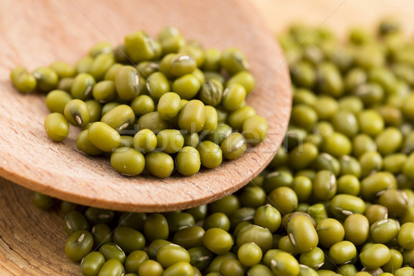 Mung beans over wooden spoon Stock photo © joannawnuk