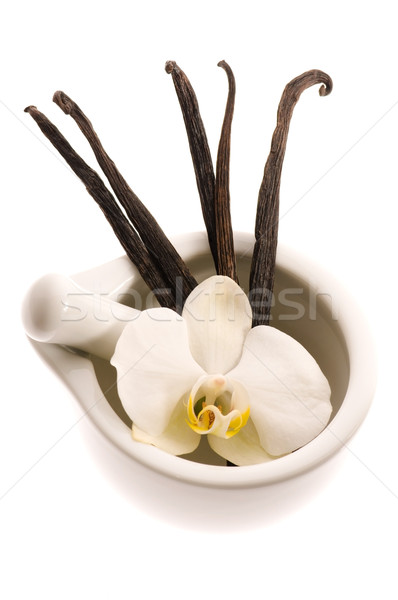 mortar with vanilla pods and flower Stock photo © joannawnuk