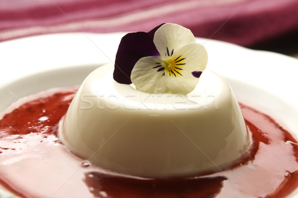Vanilla panna cotta with berry sauce and spring flower Stock photo © joannawnuk