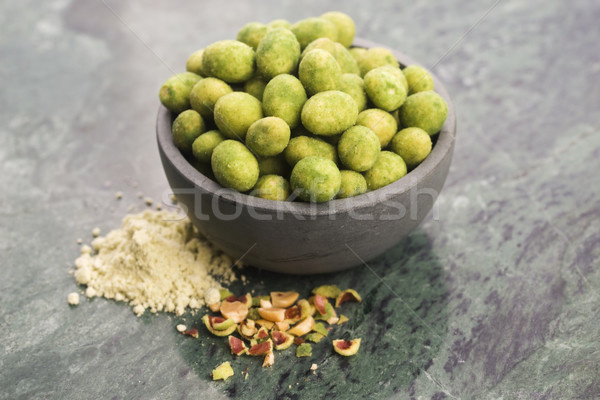 Stock photo: Pile of wasabi coated peanuts in bowl