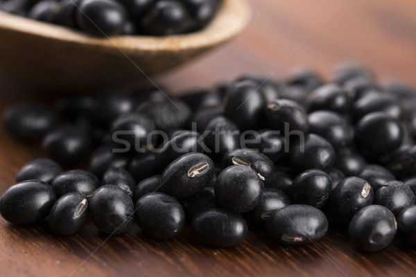 A lot of black soybeans on wooden background Stock photo © joannawnuk