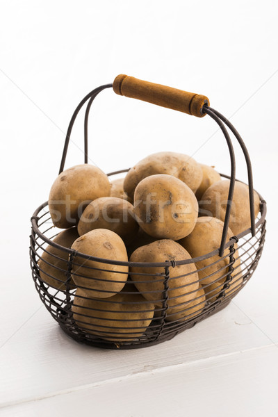 uncooked potatoes in wire basket Stock photo © joannawnuk