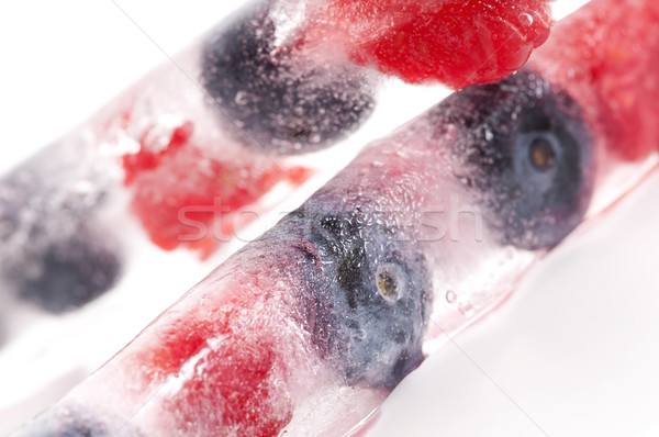 Raspberry and blackberry frozen in ice sticks Stock photo © joannawnuk