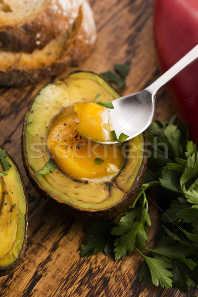 Homemade Organic Egg Baked in Avocado with Salt and Pepper Stock photo © joannawnuk