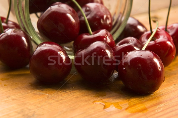 Cherry in glass jar isolated on the wooden background Stock photo © joannawnuk