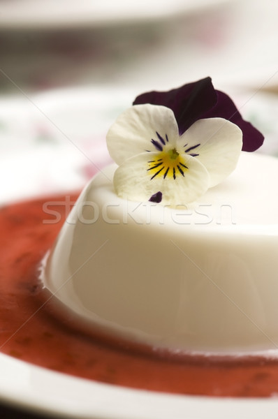 Vanilla panna cotta with berry sauce and spring flower Stock photo © joannawnuk