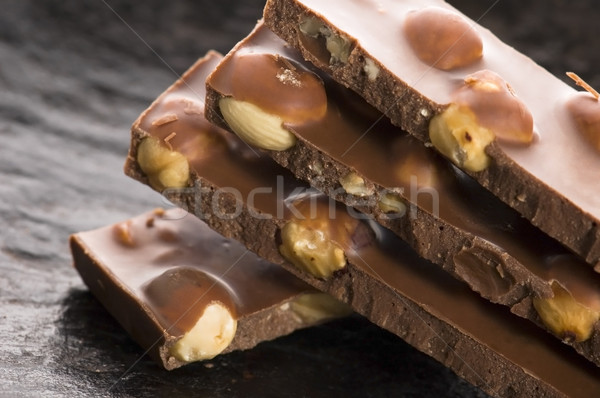 Pile of broken chocolate with nuts Stock photo © joannawnuk