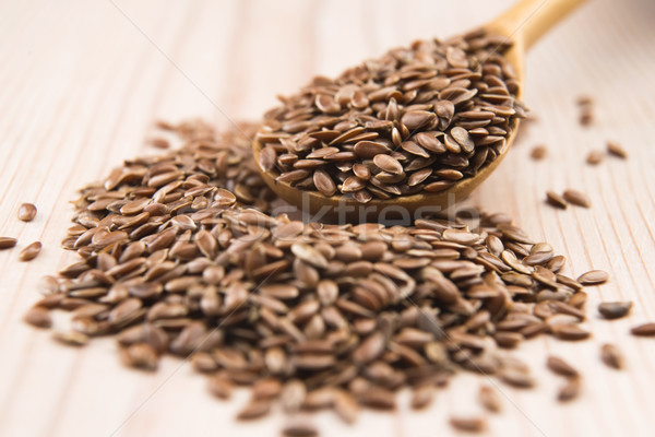 Wooden spoon with flax seed Stock photo © joannawnuk
