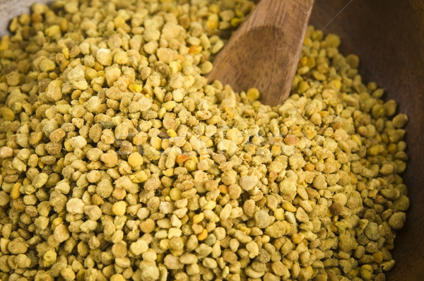 Bee pollen in wooden scoop. Nutritional supplement Stock photo © joannawnuk