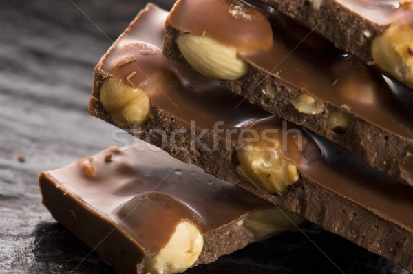 Pile of broken chocolate with nuts Stock photo © joannawnuk