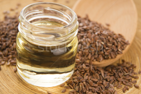 Linseed oil and flax seeds on wooden background  Stock photo © joannawnuk