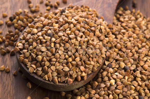 Buckwheat seeds on wooden spoon in closeup  Stock photo © joannawnuk