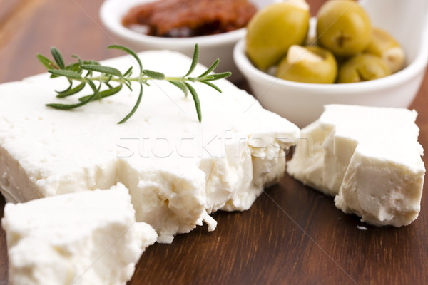 Feta cheese with olives, sun dried tomatoes and fresh herbs Stock photo © joannawnuk