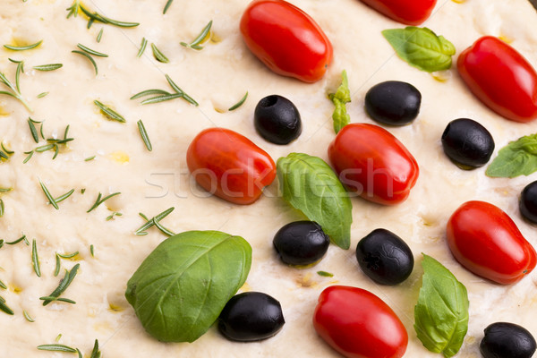 Focaccia with black olives, tomatoes and basil Stock photo © joannawnuk