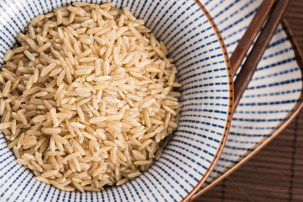 Raw brown rice in a bowl Stock photo © joannawnuk
