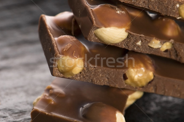 Pile of broken chocolate with nuts Stock photo © joannawnuk