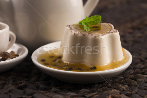 Panna cotta dessert with passion fruit and mint Stock photo © joannawnuk