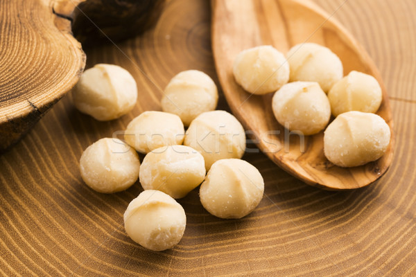 Stock photo: Roasted Macadamia nuts on rustic wooden background