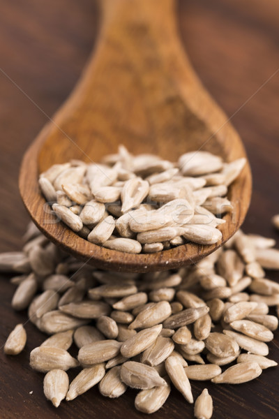 Sunflower seed with a wooden spoon Stock photo © joannawnuk