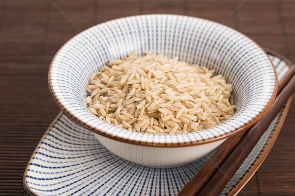 Raw brown rice in a bowl Stock photo © joannawnuk