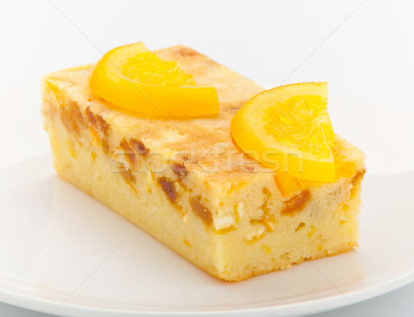 Orange cake melted with pieces of orange and topping on it for d Stock photo © JohnKasawa