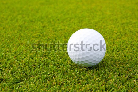 Stock photo: Golfball on green field