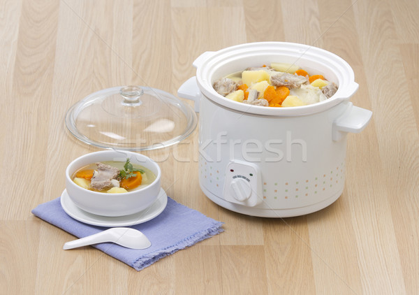 Stock photo: Electric casserole or stew pot on the wooden kitchen table