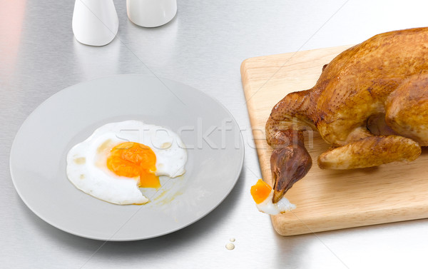 Hungry toasted chicken eating egg the conceptual image Stock photo © JohnKasawa