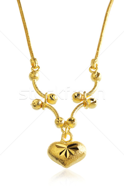 Golden necklace pendant with heart shape Stock photo © JohnKasawa