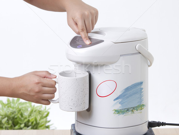 Pouring hot drinking from electric water boiler pot Stock photo © JohnKasawa
