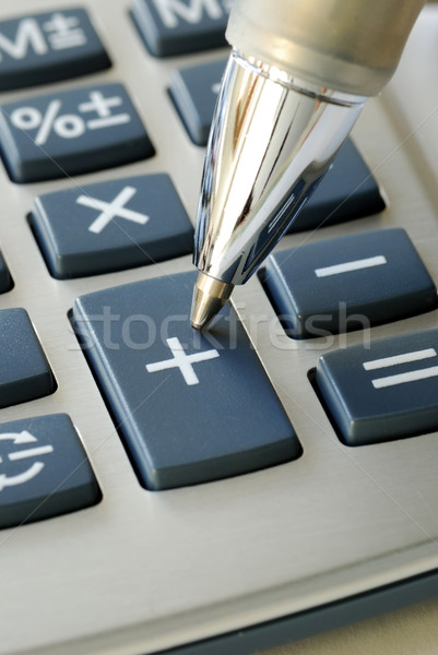 The pen pointing to the add button in the calculator Stock photo © johnkwan