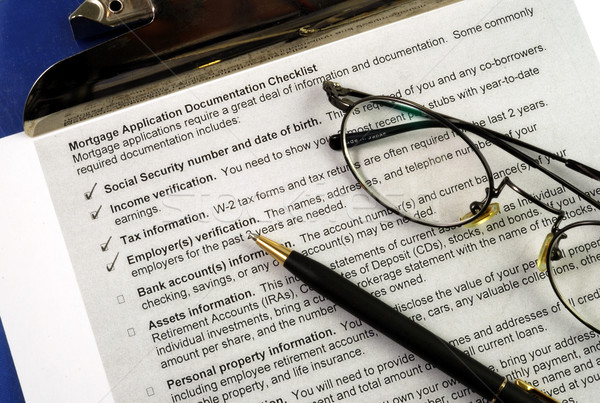 Stock photo: The documents required in a mortgage application isolated on blue
