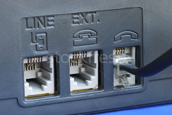 Line connectors at the back of a fax machine isolated on blue Stock photo © johnkwan