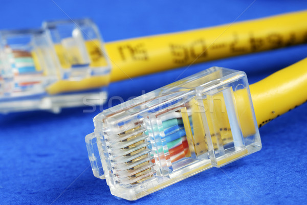 Close-up view of the yellow Ethernet (RJ45) network cable isolated on blue Stock photo © johnkwan