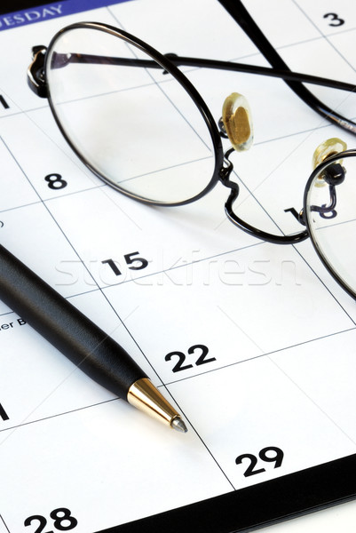 Planning the new month from a calendar with a pen Stock photo © johnkwan