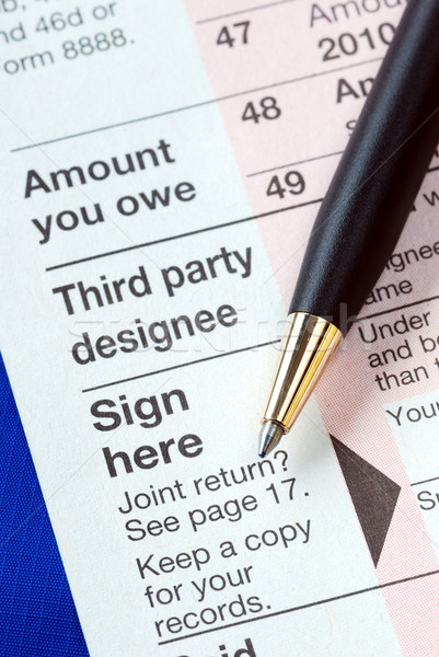 Sign the income tax return isolated on blue Stock photo © johnkwan