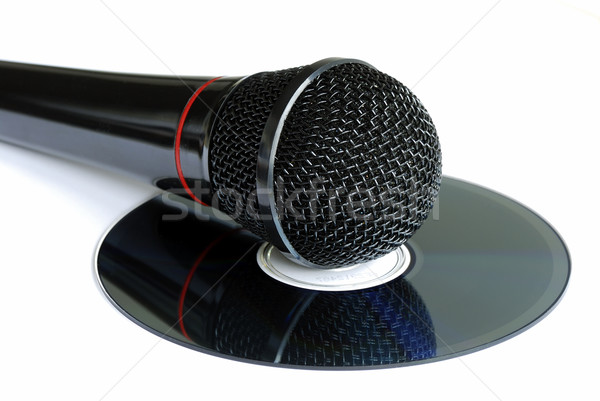 A microphone on a CD concepts Karaoke and piracy Stock photo © johnkwan