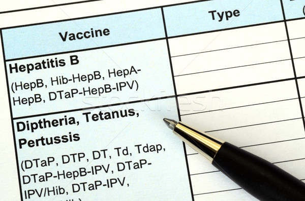 Stock photo: Filling the vaccination record concept of disease prevention and immunization