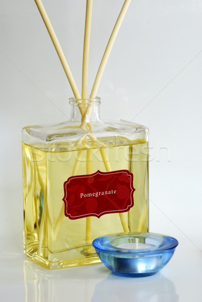 Stock photo: Fragrance oil with scented diffuser and a blue candle holder