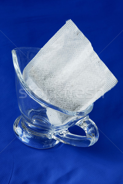 A tea bag in a glass jar isolated on blue Stock photo © johnkwan