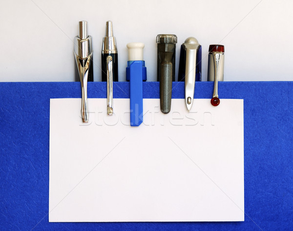 Many pens clipping the white business card: Your Text is Here Stock photo © johnkwan