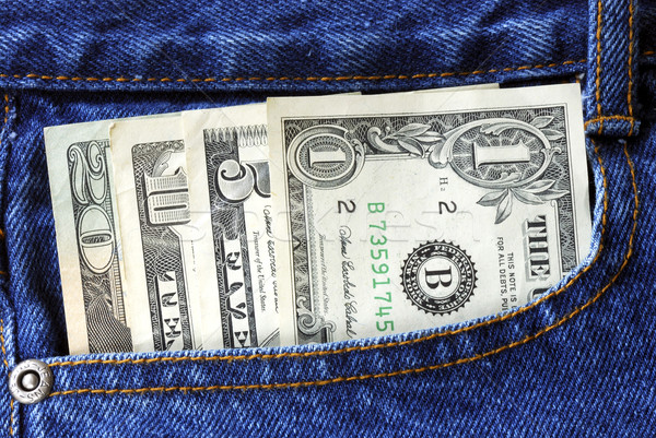 Stock photo: American money is in the pocket of blue jeans