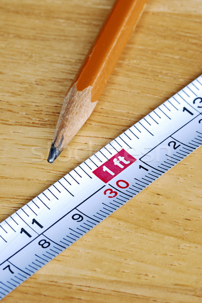 Stock photo: Measuring tape and pencil are tools for carpenters 