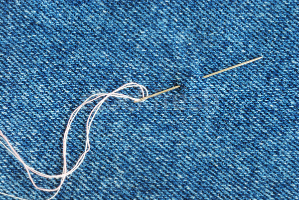 The needle with a thread through the jeans Stock photo © johnkwan