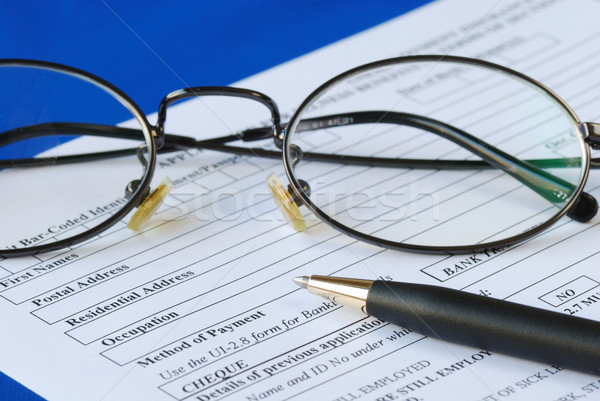 Fill out the personal information in an application isolated on blue Stock photo © johnkwan