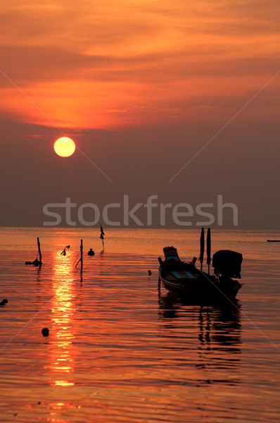 Sunset with boat on tropical beach Stock photo © johnnychaos