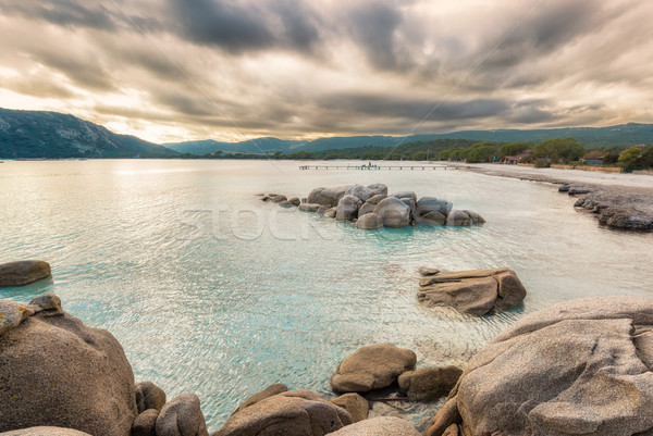 Boulders in a turquoise sea at Santa Giulia beach in Corsica Stock photo © Joningall