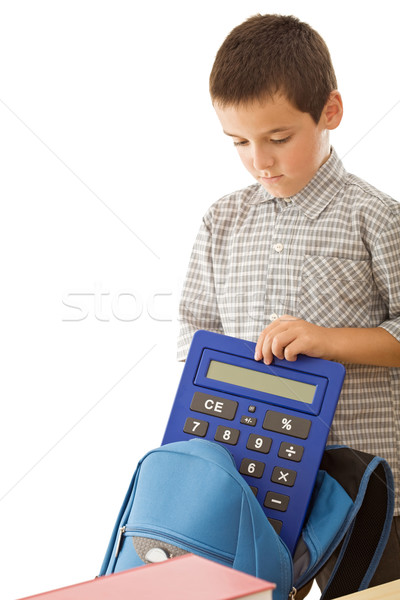Schoolboy putting a calculator in the schoolbag Stock photo © joseph73